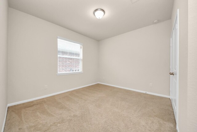carpeted spare room with baseboards