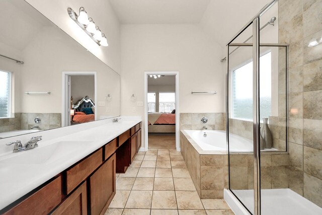 bathroom featuring a stall shower, a garden tub, ensuite bathroom, and a sink