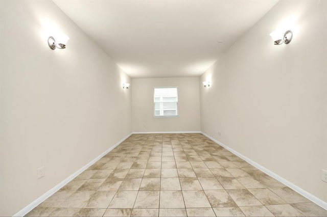 unfurnished room with baseboards