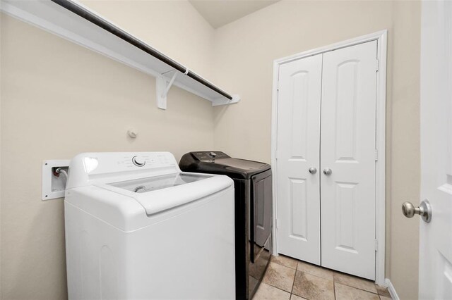 laundry room featuring separate washer and dryer, laundry area, and baseboards