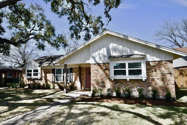 view of front of house featuring brick siding and board and batten siding