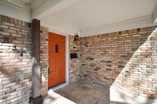 property entrance with brick siding