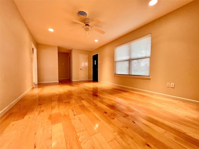 spare room with baseboards, recessed lighting, a ceiling fan, light wood-style floors, and visible vents