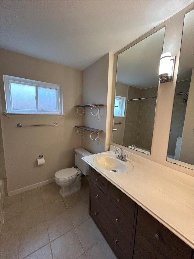 bathroom with vanity, baseboards, tile patterned flooring, toilet, and tiled shower