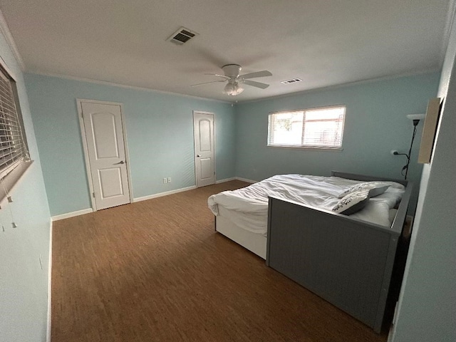 bedroom featuring visible vents, ceiling fan, wood finished floors, and baseboards