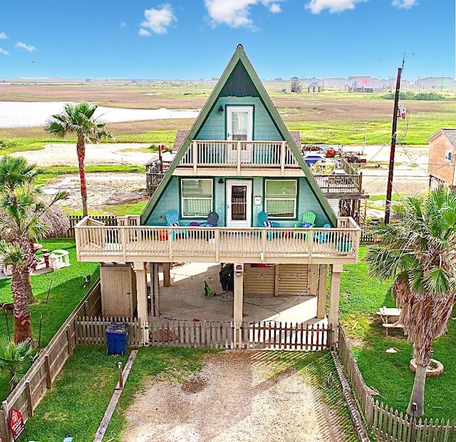 234 Sandpebble Pl, Surfside Beach, TX 77541 - view of front of property featuring a fenced backyard, a balcony, dirt driveway, and a deck