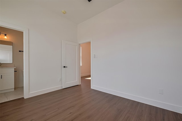 unfurnished bedroom featuring baseboards and dark wood finished floors