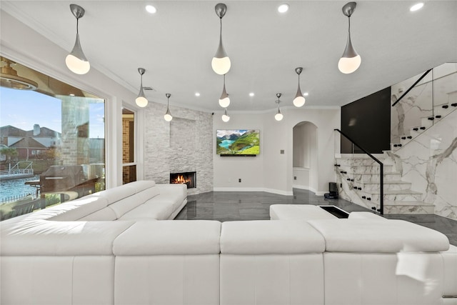 living area featuring crown molding, recessed lighting, arched walkways, and stairs