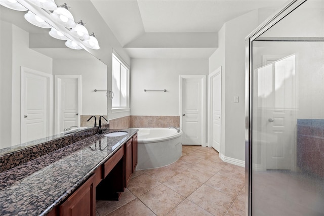 bathroom featuring tile patterned flooring, a bath, a shower stall, and vanity