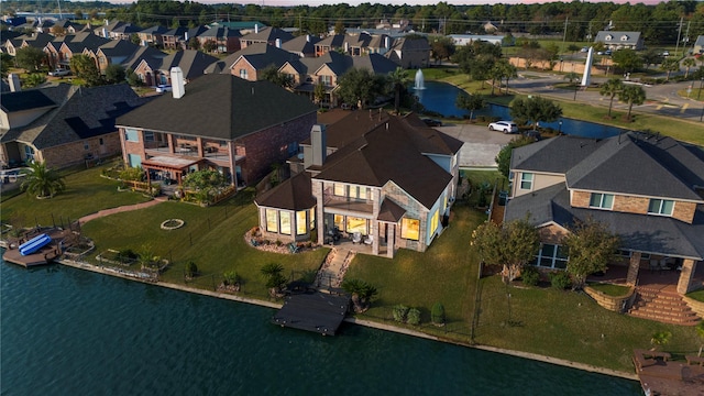 aerial view with a water view and a residential view
