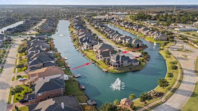 birds eye view of property featuring a water view and a residential view