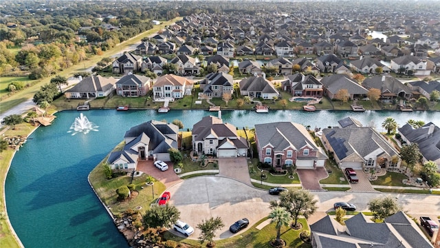 drone / aerial view featuring a water view and a residential view