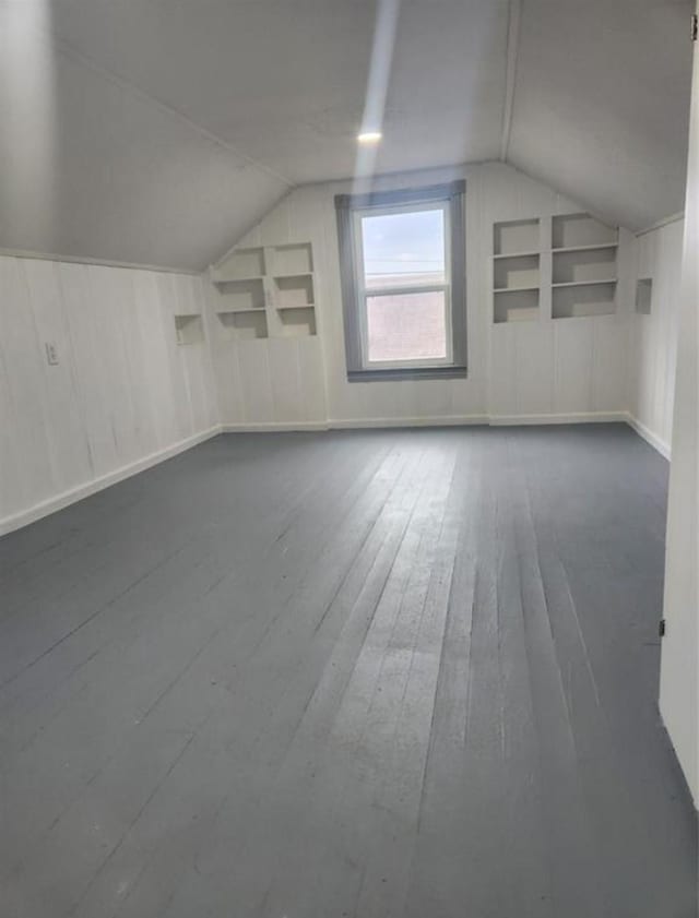 bonus room featuring hardwood / wood-style floors and vaulted ceiling