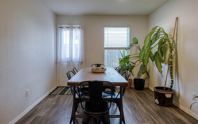 dining room with baseboards and dark wood finished floors