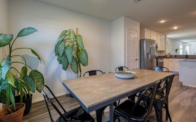 dining space with recessed lighting, dark wood-style floors, baseboards, and visible vents