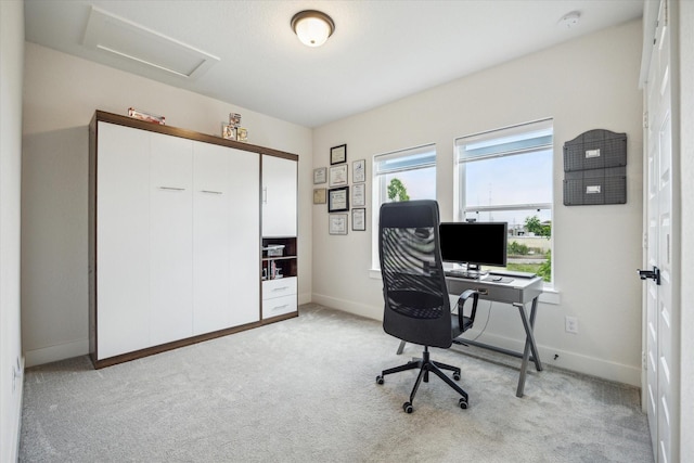 office featuring light colored carpet, baseboards, and attic access