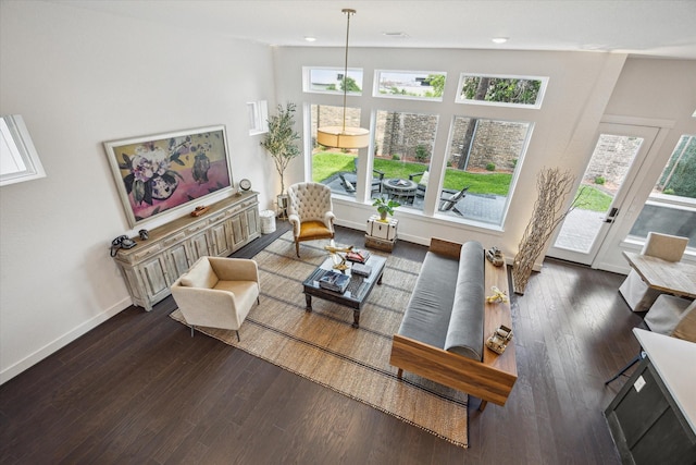 living area with wood finished floors and baseboards