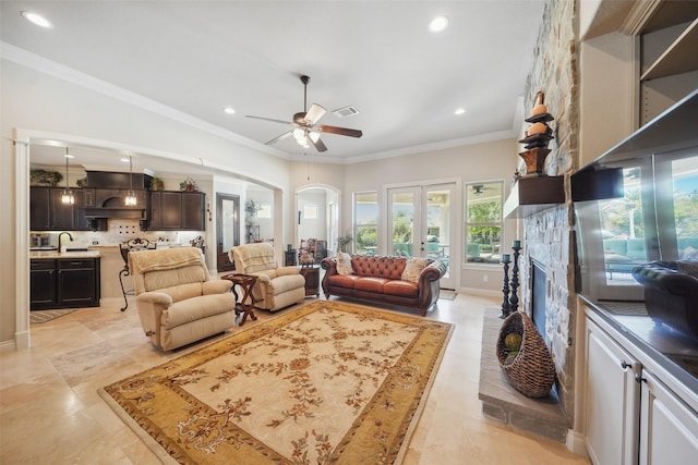 5924 Oak Leaf Ct, Conroe, TX 77304 - living area featuring ornamental molding, recessed lighting, arched walkways, a ceiling fan, and a fireplace