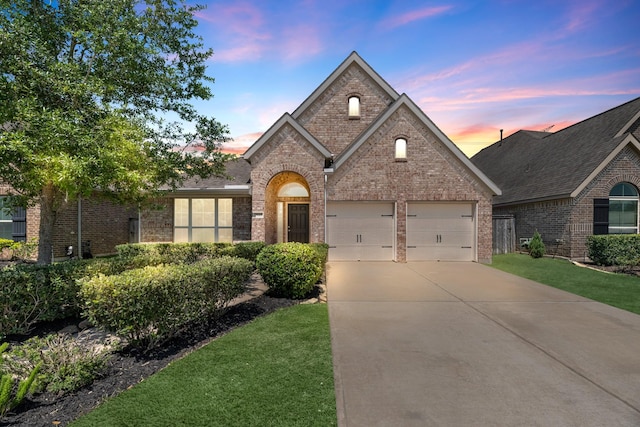 view of front of property featuring brick siding, roof with shingles, a garage, and concrete driveway