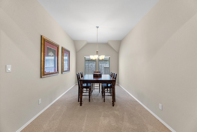 carpeted dining area with a chandelier, baseboards, and lofted ceiling