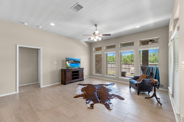 living area featuring light tile patterned floors, ceiling fan, visible vents, recessed lighting, and baseboards