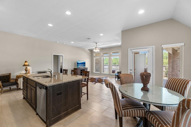 kitchen featuring recessed lighting, open floor plan, dishwasher, and a sink