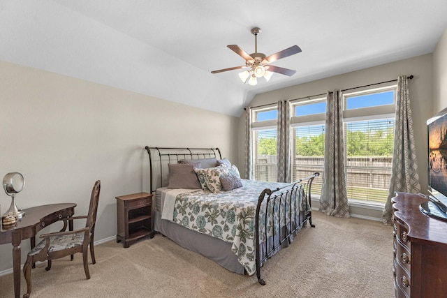 bedroom with baseboards, ceiling fan, light carpet, and lofted ceiling