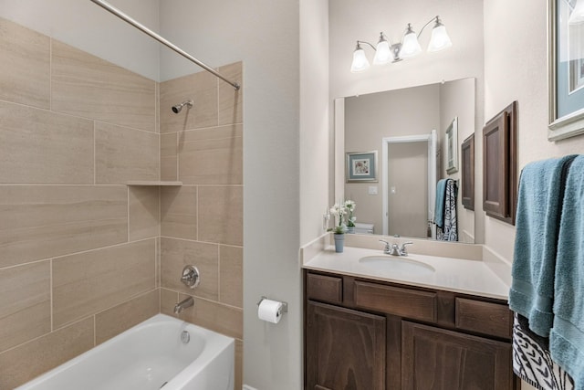 bathroom featuring washtub / shower combination and vanity