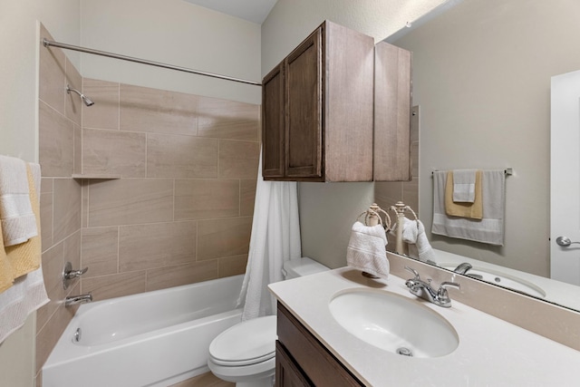 bathroom featuring toilet, shower / tub combo with curtain, and vanity