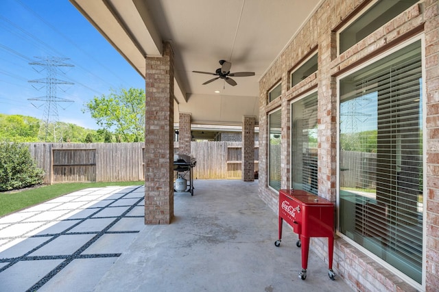 view of patio with ceiling fan, fence, and area for grilling