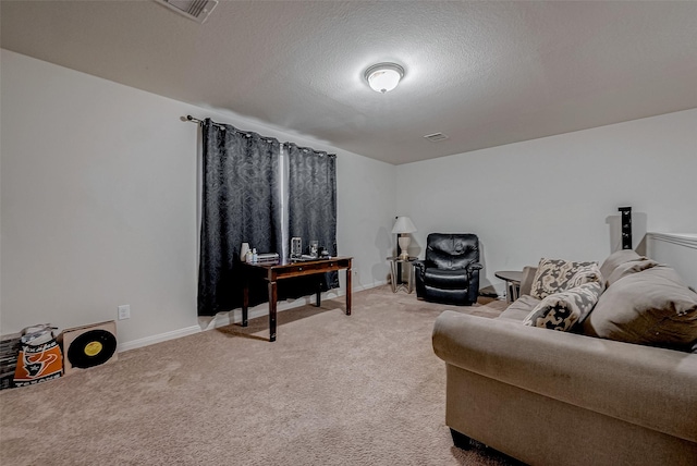 living area featuring light carpet, visible vents, baseboards, and a textured ceiling
