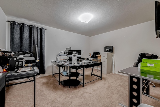 home office with light colored carpet and a textured ceiling
