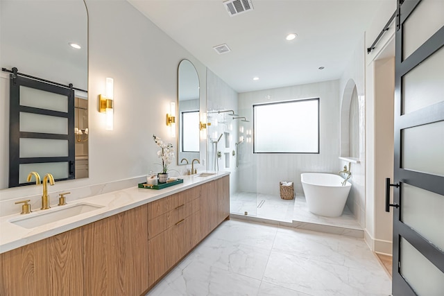 829 Alexander St, Houston, TX 77007 - full bathroom with walk in shower, marble finish flooring, a soaking tub, double vanity, and recessed lighting