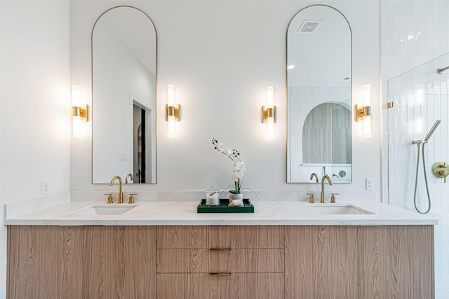 full bathroom with a sink, visible vents, and double vanity