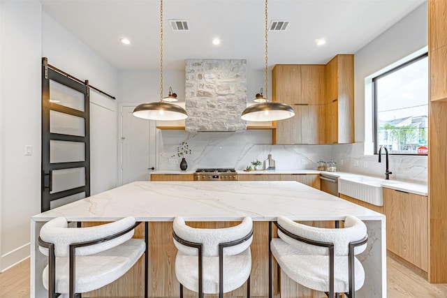 kitchen with modern cabinets, visible vents, and a barn door