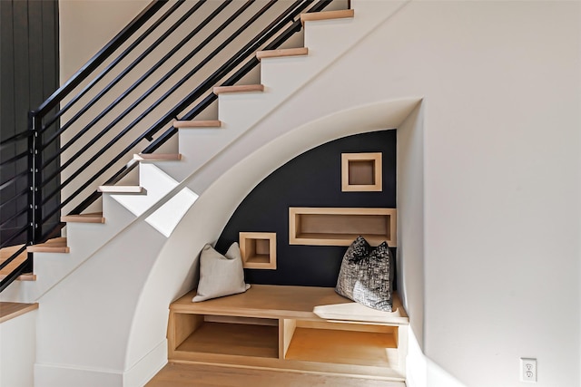 stairs featuring wood finished floors