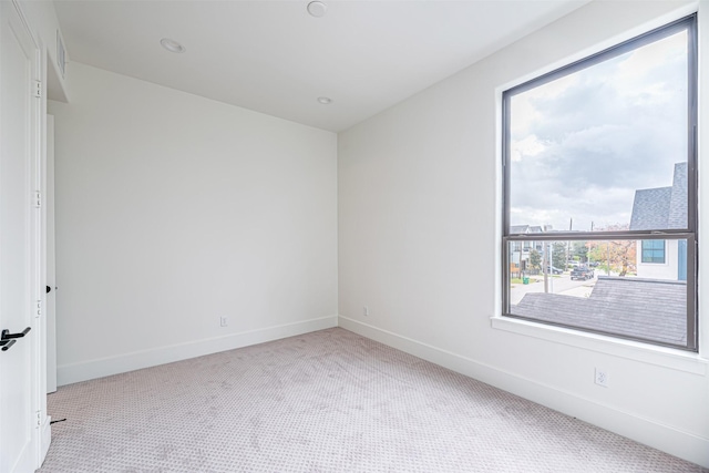 spare room featuring baseboards and carpet floors