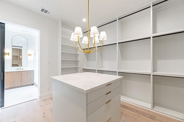 829 Alexander St, Houston, TX 77007 - walk in closet with light wood finished floors and a chandelier