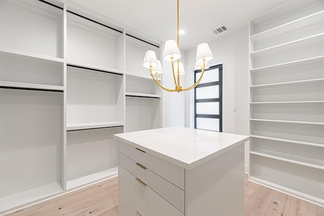 829 Alexander St, Houston, TX 77007 - spacious closet featuring light wood finished floors and a chandelier