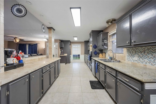 13918 Bretagne Dr, Houston, TX 77015 - kitchen with tasteful backsplash, a sink, light tile patterned floors, ceiling fan, and light countertops