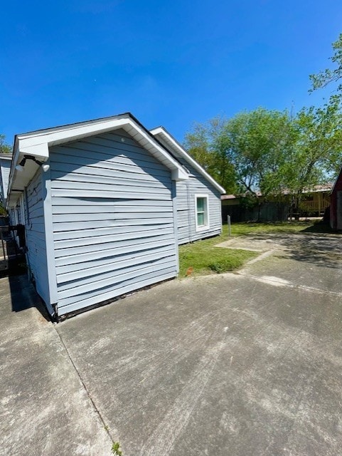 view of side of property with a patio area and fence