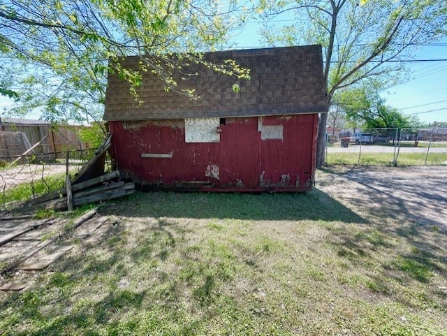 view of shed featuring fence