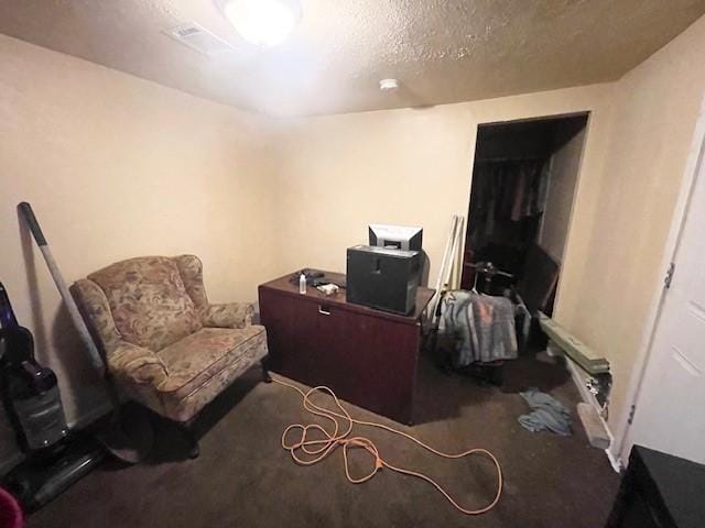 sitting room featuring a textured ceiling and carpet floors