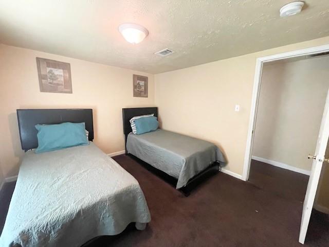 bedroom with carpet flooring and baseboards