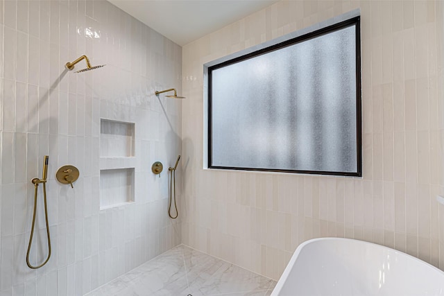 bathroom featuring a tile shower and a soaking tub