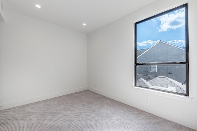 carpeted spare room with recessed lighting and baseboards