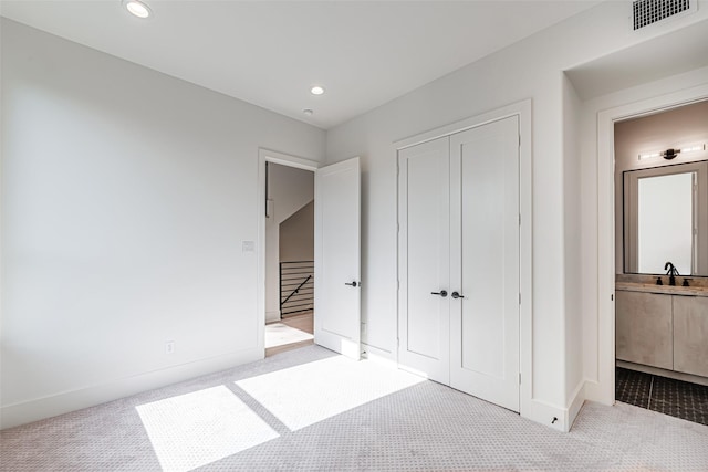 unfurnished bedroom with visible vents, baseboards, carpet, and recessed lighting