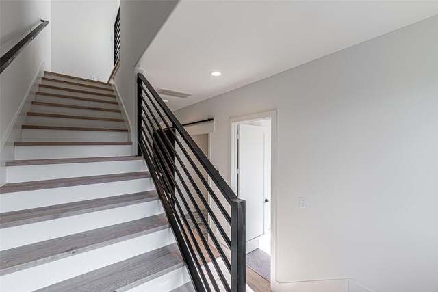 stairs featuring recessed lighting