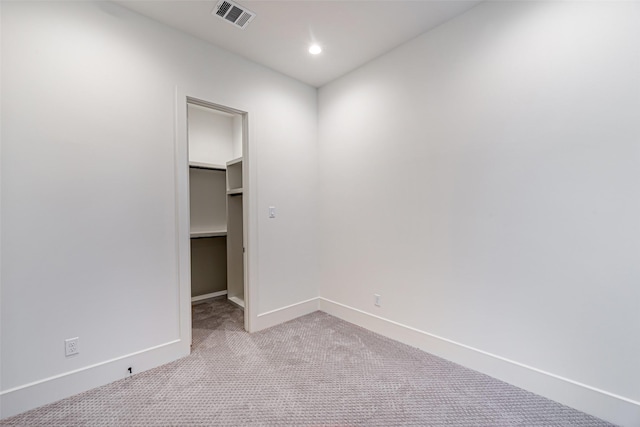unfurnished room featuring recessed lighting, carpet flooring, visible vents, and baseboards
