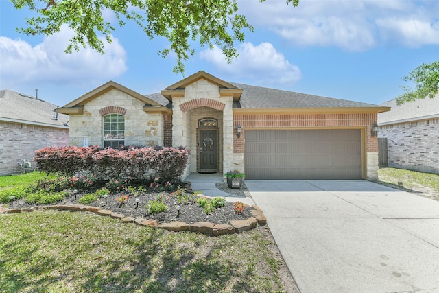 21320 Heritage Forest Ln, Porter, TX 77365 - french country inspired facade featuring stone siding, a garage, concrete driveway, roof with shingles, and brick siding